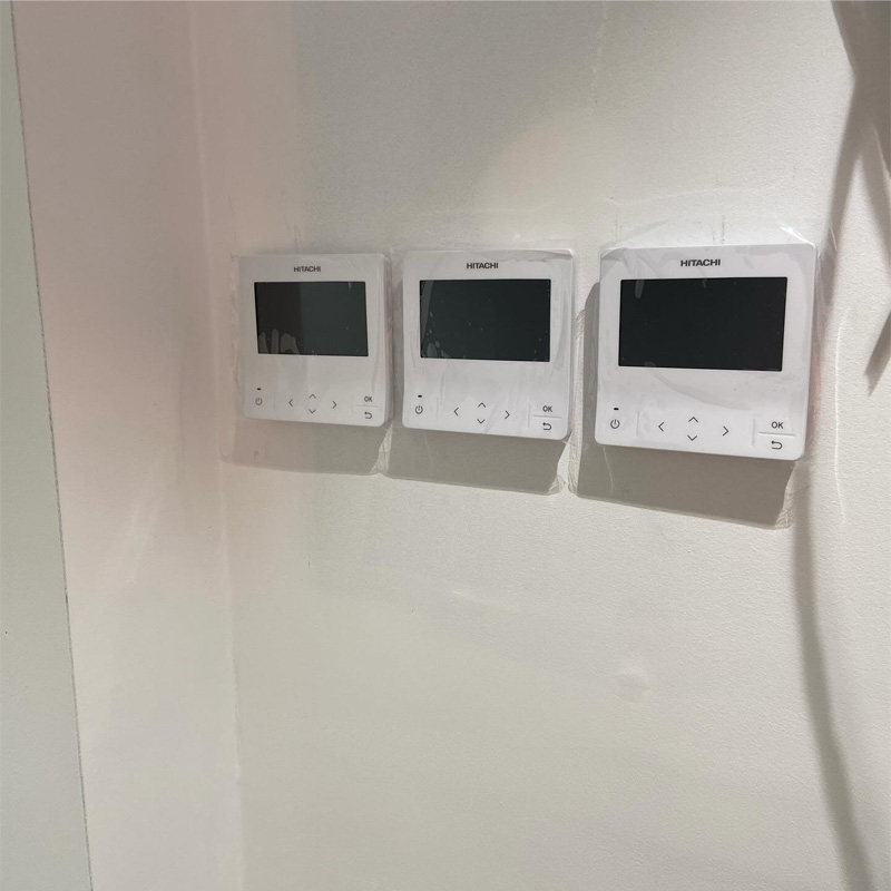 Three air conditioning wall controllers mounted side by side